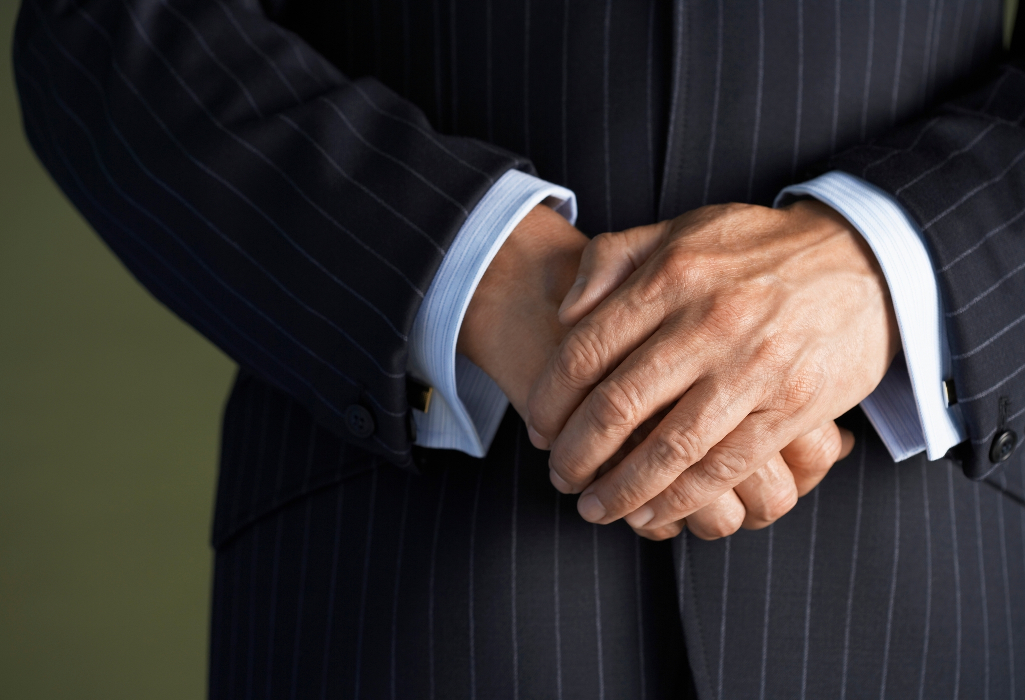 man in a suit with cuffs showing