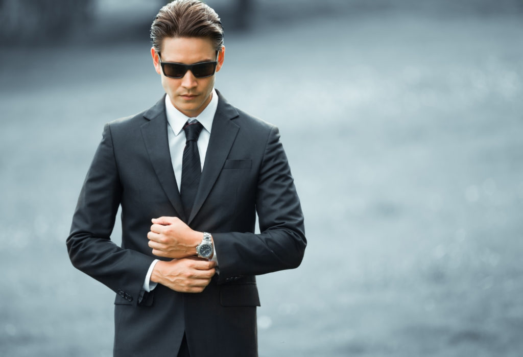 man in black suit with watch - fashionable men's accessories