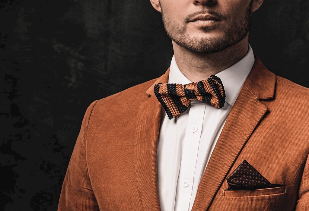 Man in orange suit and bow tie