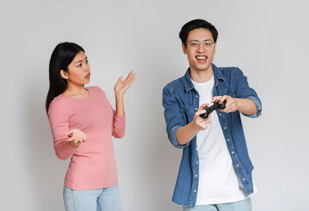 a man selfishly playing video games and ignoring his girlfriend turns her off